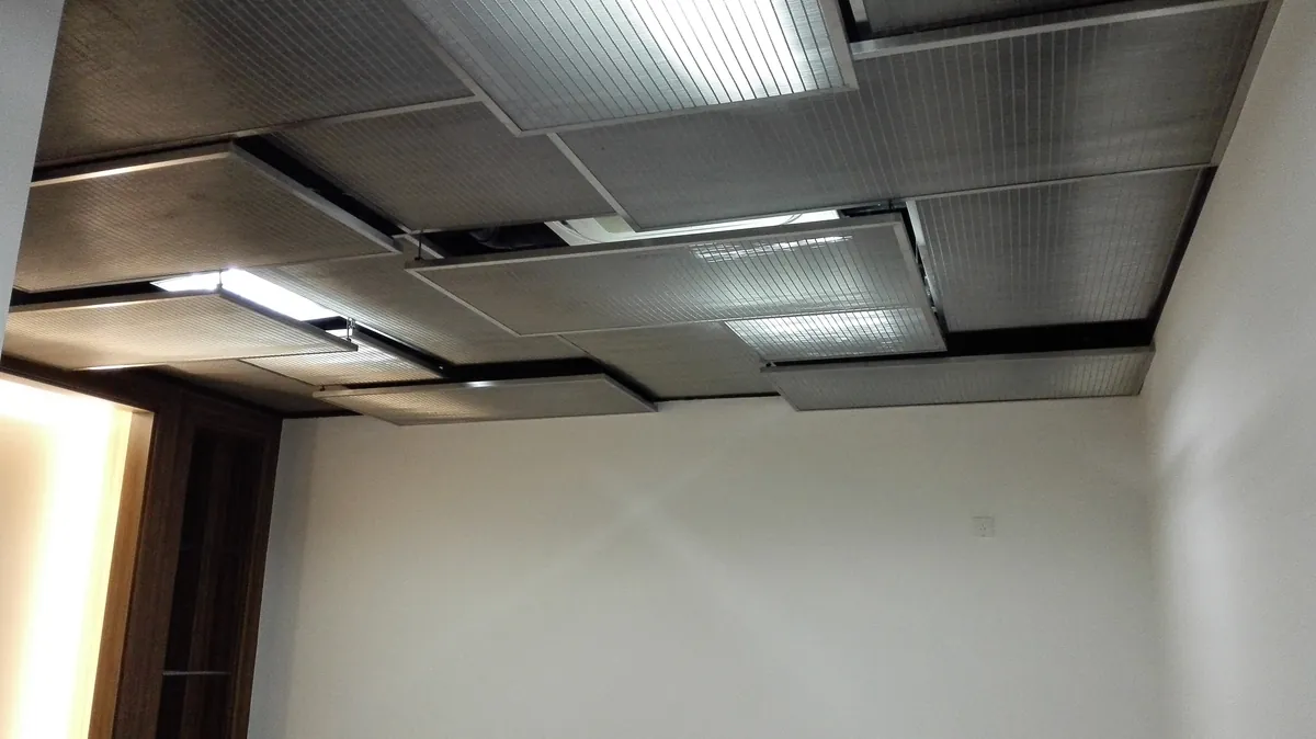 Rectangular metal mesh ceiling modules shown as an application reference