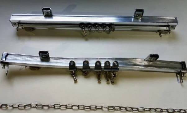 Metal curtain track and carrier components shown as an installation reference