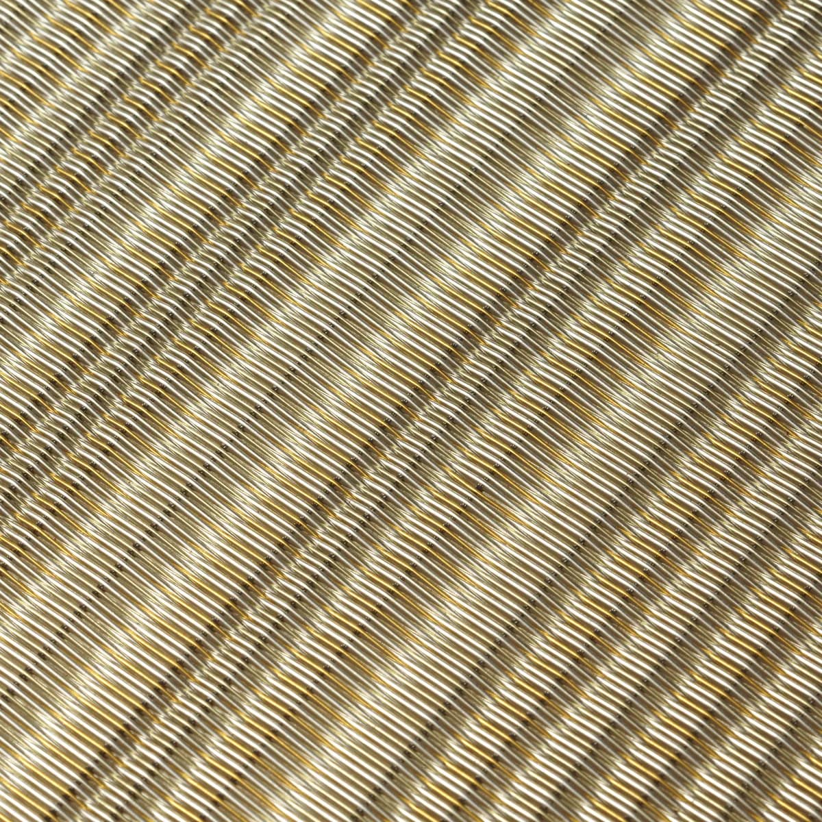 Bronze-finish architectural mesh detail illustrating direction, alignment and surface continuity near boundaries