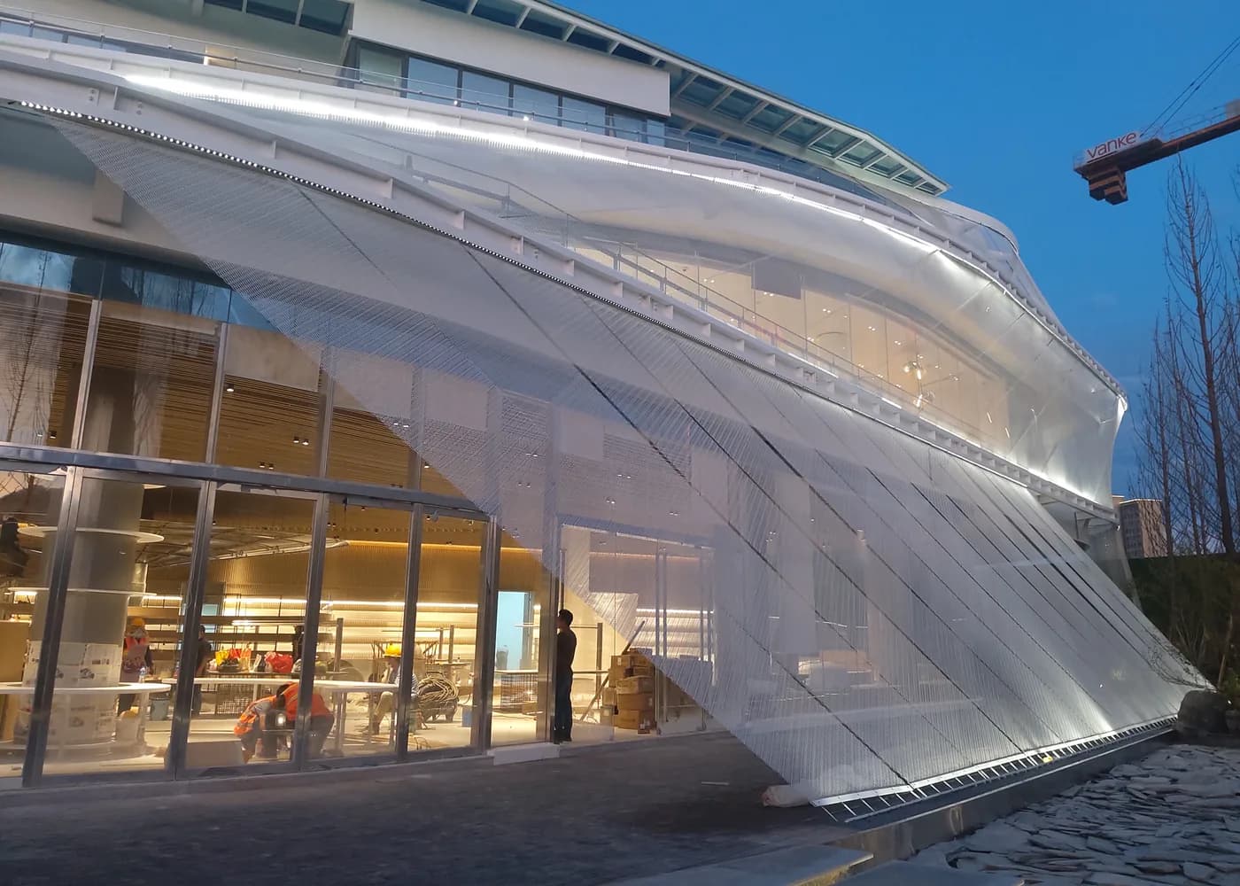 Curved architectural metal mesh facade detail