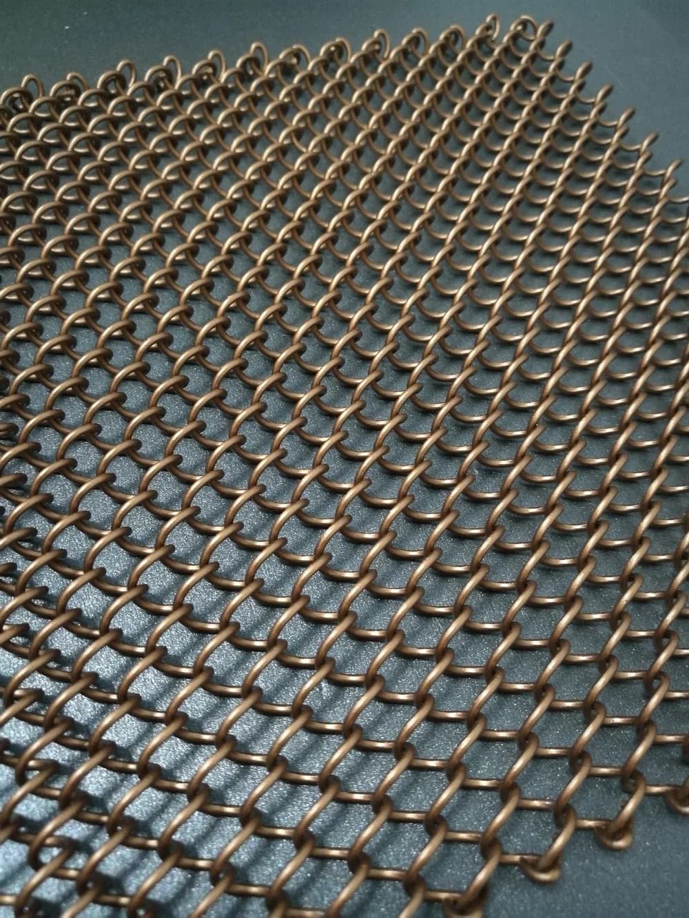 Flexible architectural coil mesh detail showing drape, continuity and changing visual density