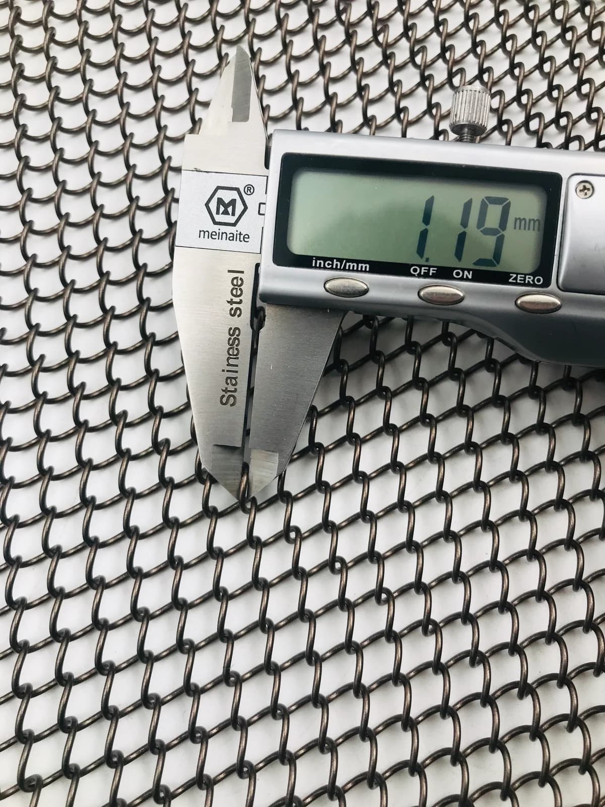 Caliper measurement shown as a sample-review process example, not a dimension for the current model